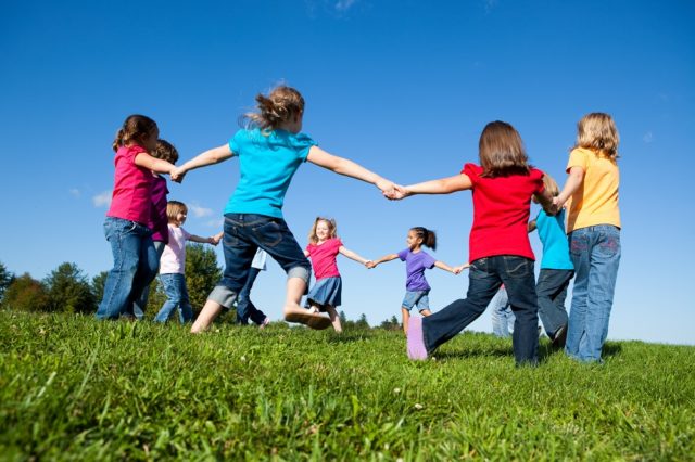 Group,Of,Girls,Holding,Hands,In,A,Circle,Outside,-